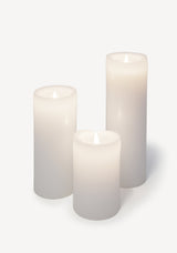 Hand poured Danish unscented white pillar candles available in three sizes for everyday use shown lit