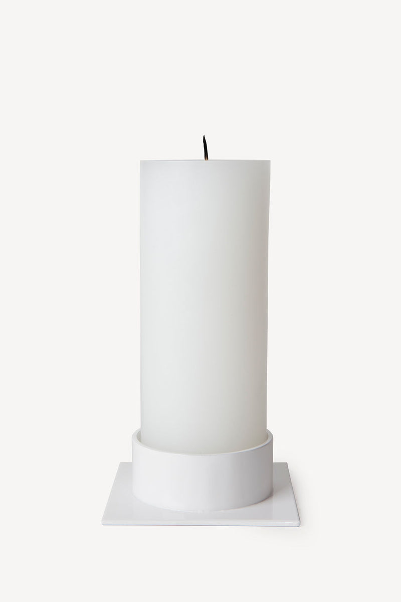 Hand poured Danish unscented white pillar candles available in three sizes for everyday use shown with matching white candle holder