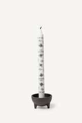 Authentic Royal Copenhagen decorative taper candles in black paired with a black cast iron candle holder.