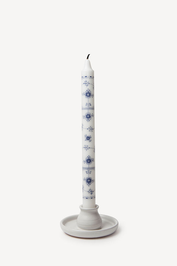 Authentic Royal Copenhagen decorative taper candles in blue paired with a clay candle holder.