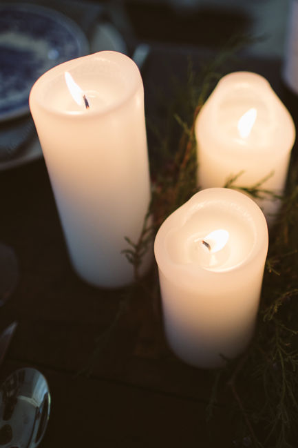 Hand poured Danish unscented white pillar candles available in three sizes for everyday use shown lit